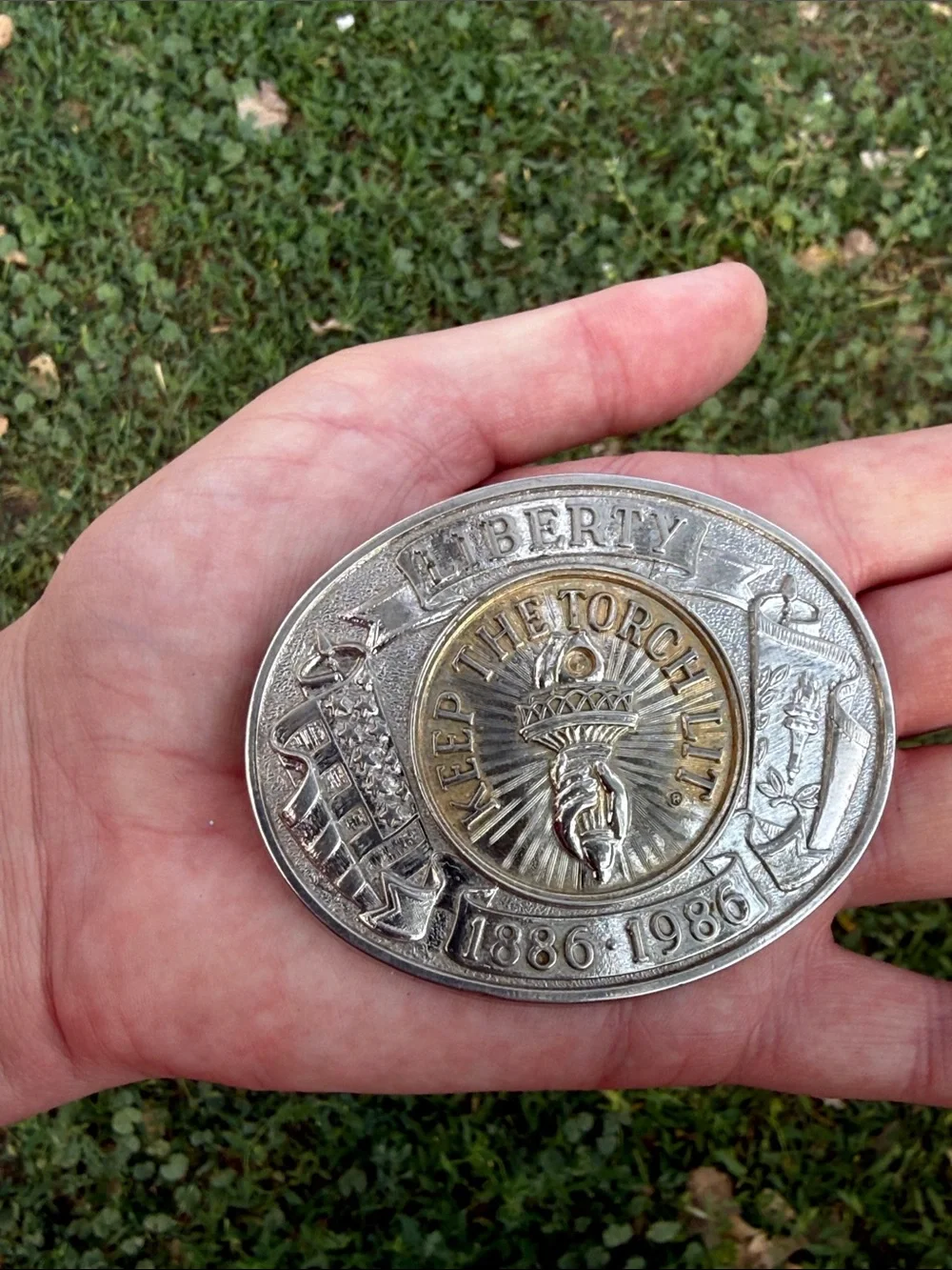 vintage silver and gold-tone belt buckle commemorates the 100th anniversary
